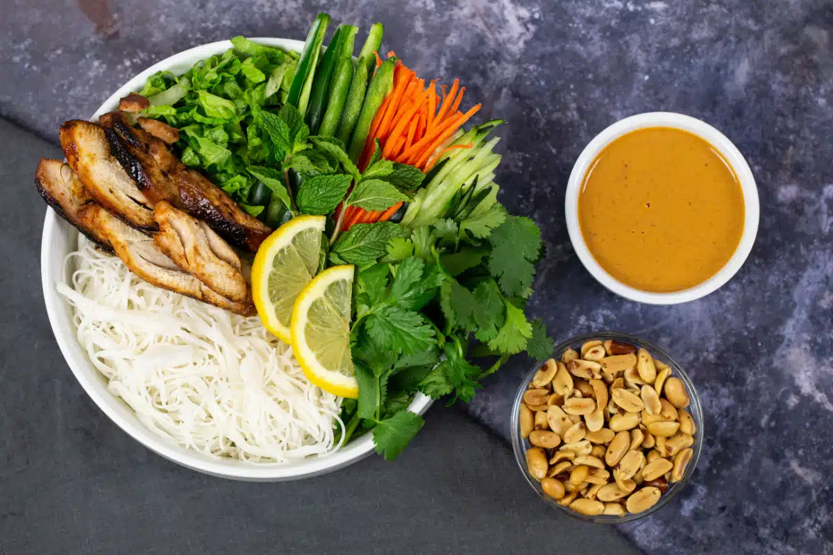 sriracha chicken noodle bowl with peanut sauce