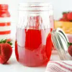 jar filled with strawberry simple syrup