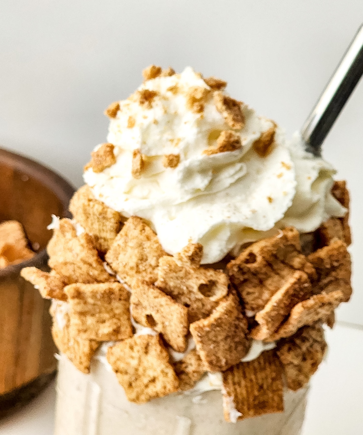 closeup of cereal garnish on a glass with milkshake