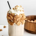 glass with cereal milkshake, straw and text overlay
