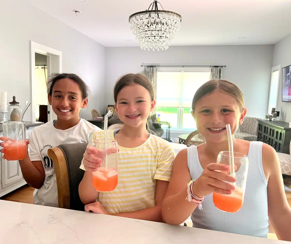 three girls tasting strawberry lemonade