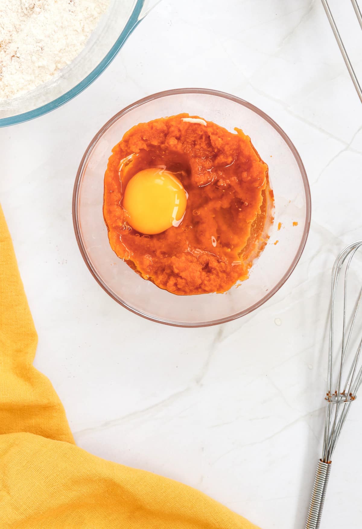 combining egg and pumpkin puree