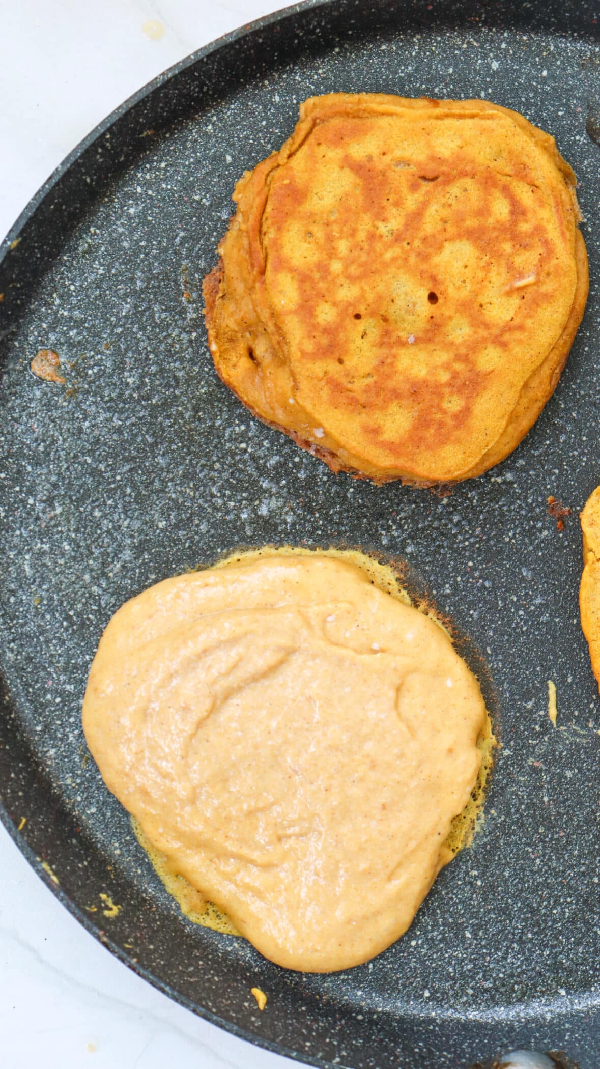 cooking pumpkin pancakes on a griddle