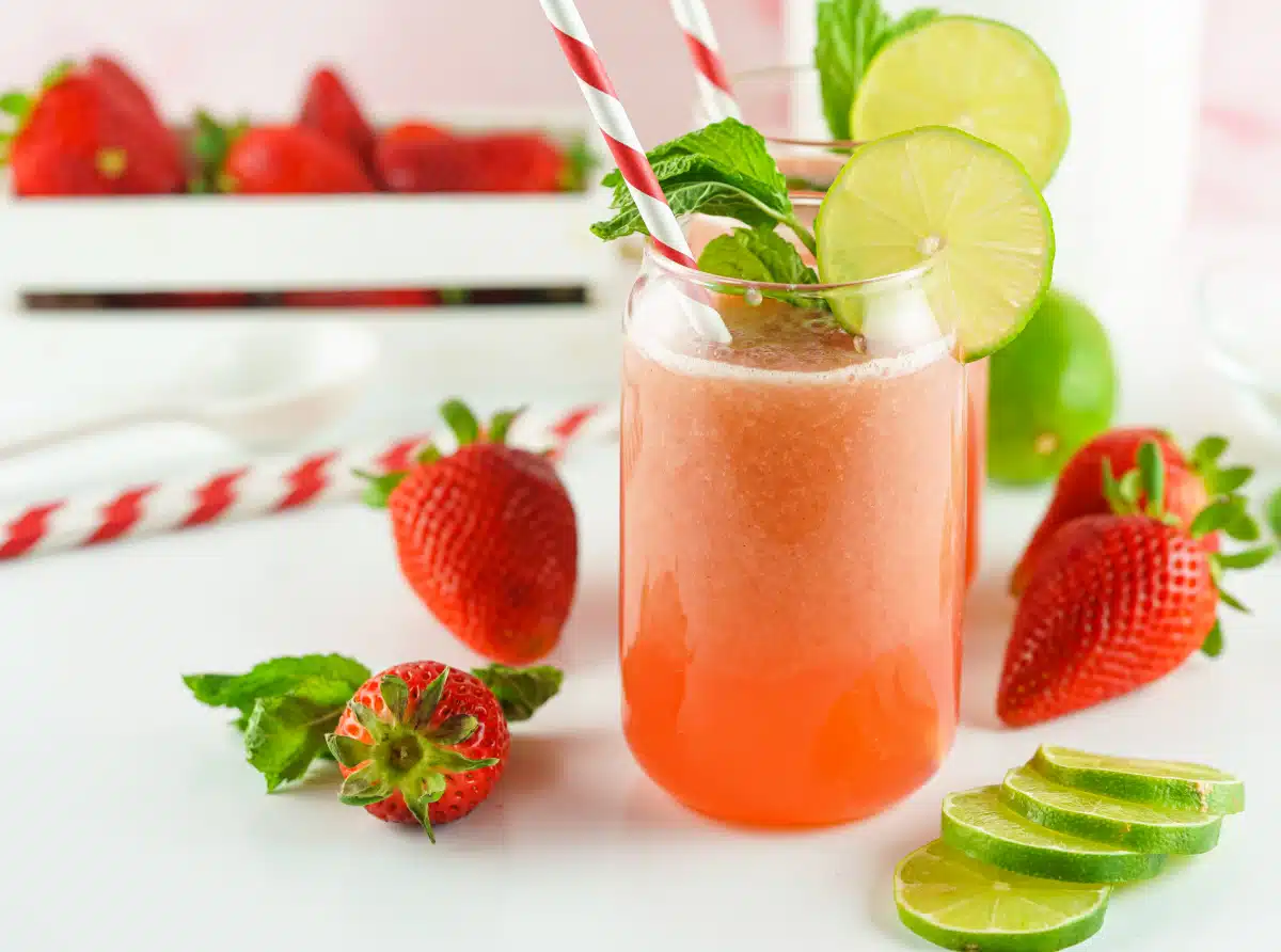 strawberry agua fresca in glasses with lime and mint
