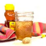 honey syrup recipe in mason jar with honey dipper