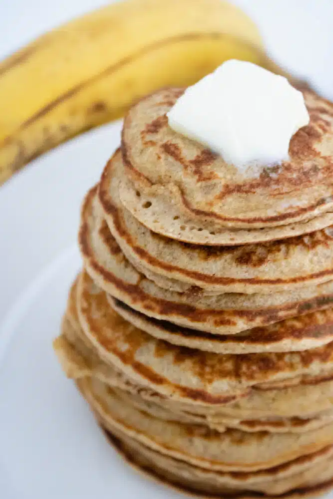 stack of banana oat pancakes with butter on top