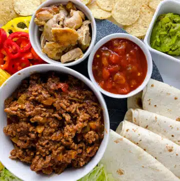 assorted taco fillings and toppings