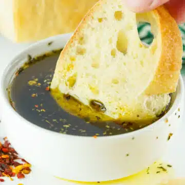 dipping bread in olive oil sauce