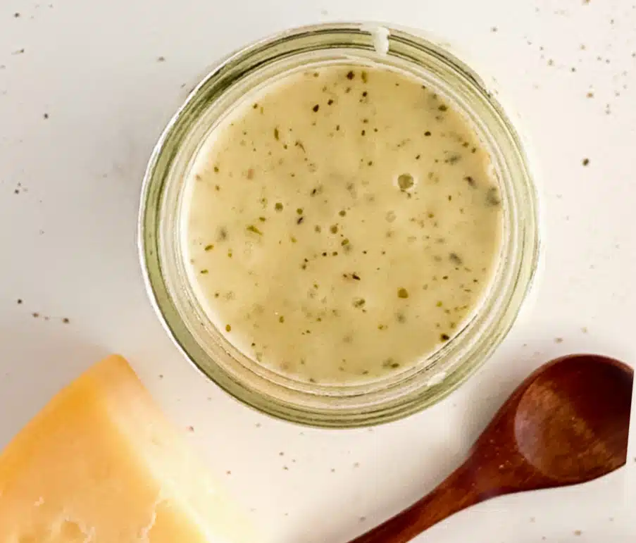 overhead photo of creamy sauce in a jar