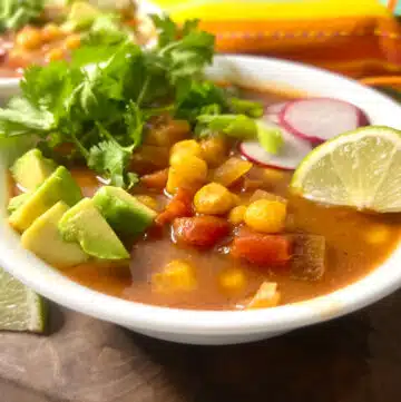 bowl of mexican hominy soup with toppings