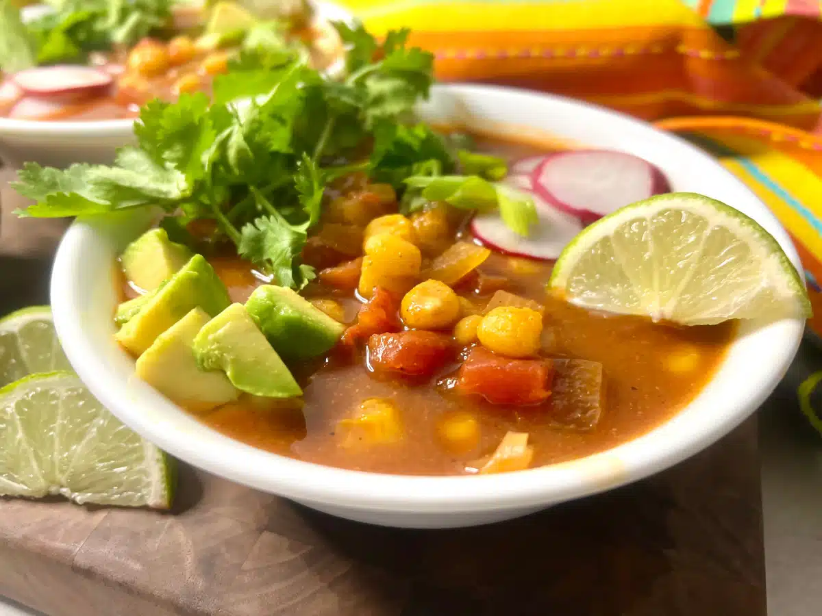 bowl of mexican hominy soup with toppings