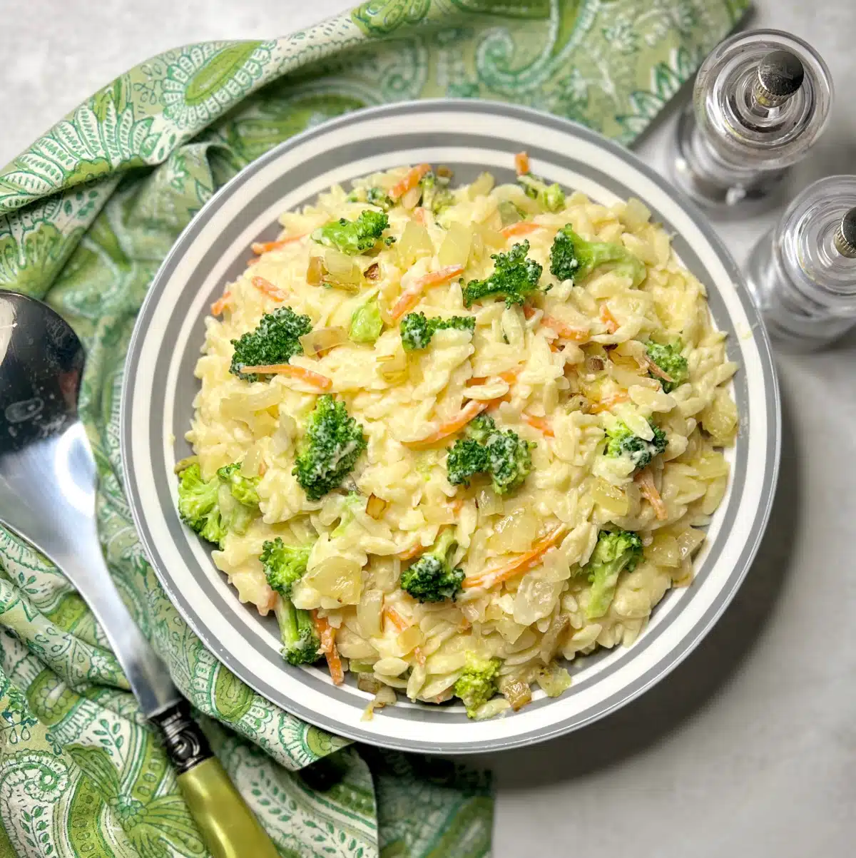 overhead photo of broccoli pasta recipe with green napkin