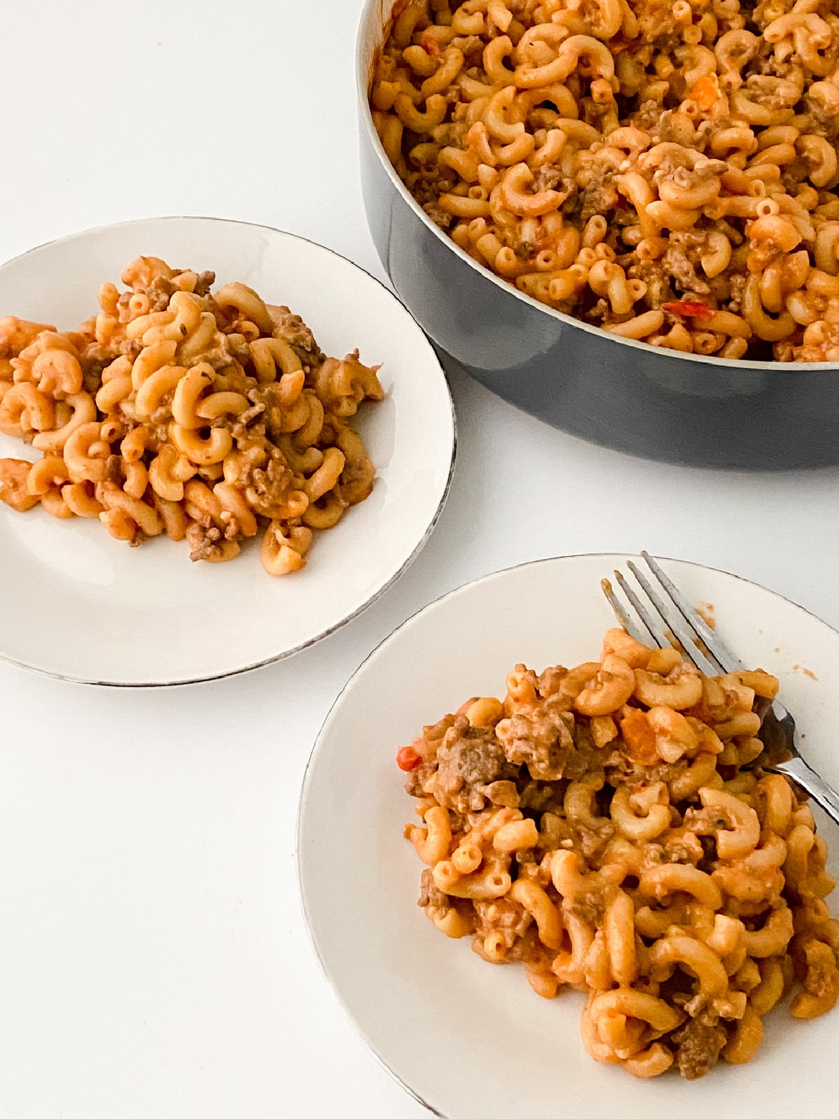 two servings of enchilada hamburger helper on white dishes