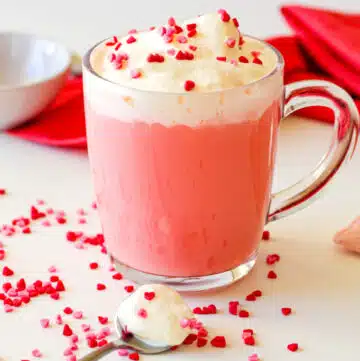 mug of strawberry hot chocolate with whipped cream and sprinkles