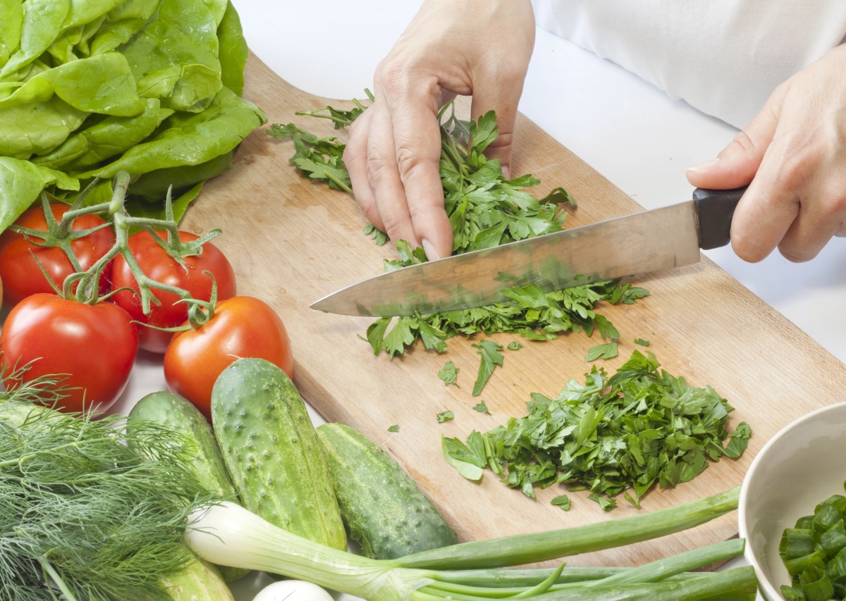 chopping parsley on a wooden board