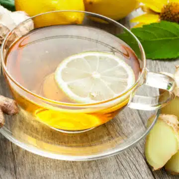 cup of homemade lemon ginger tea with lemon slice