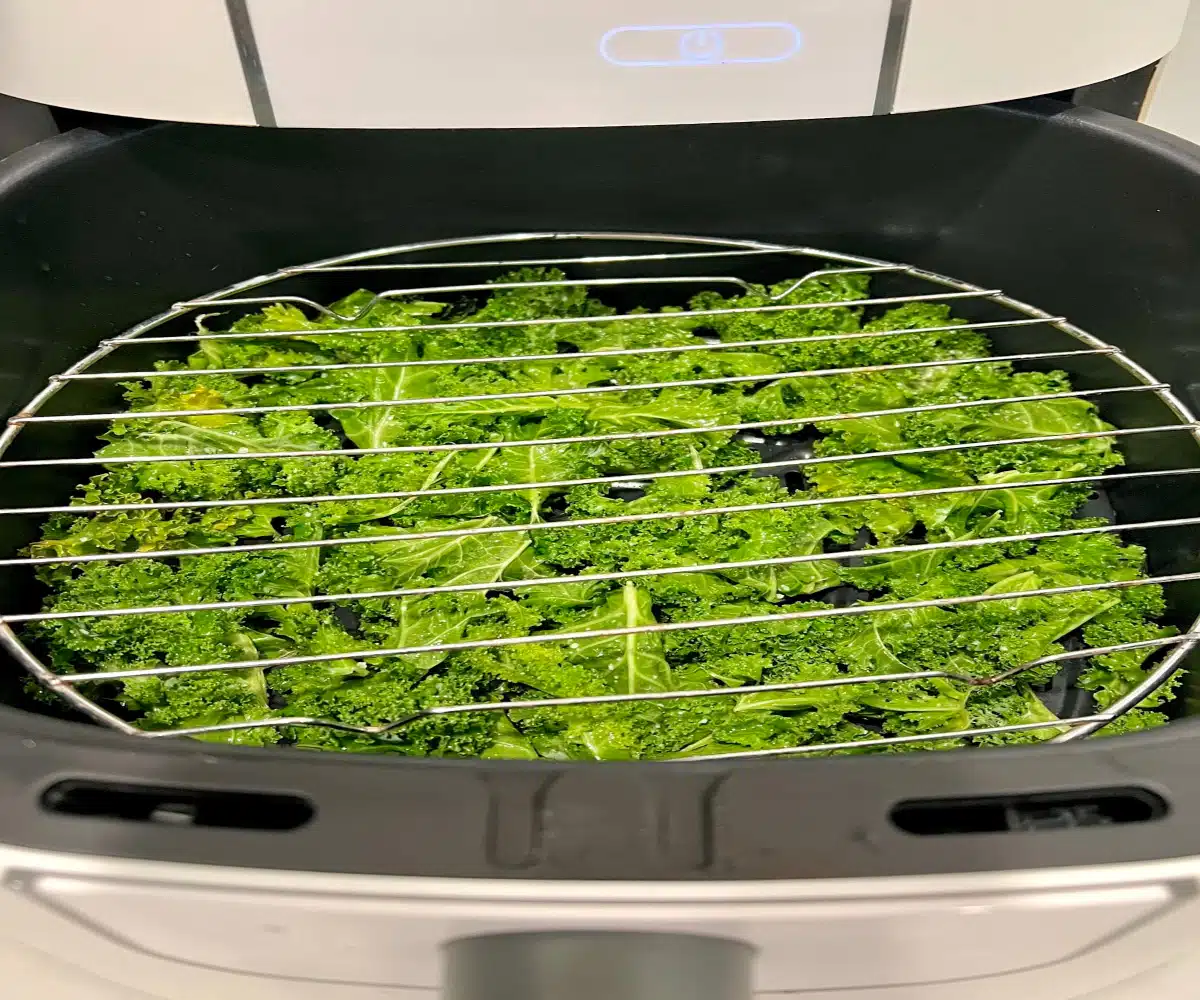 kale leaves in the air fryer with wire rack