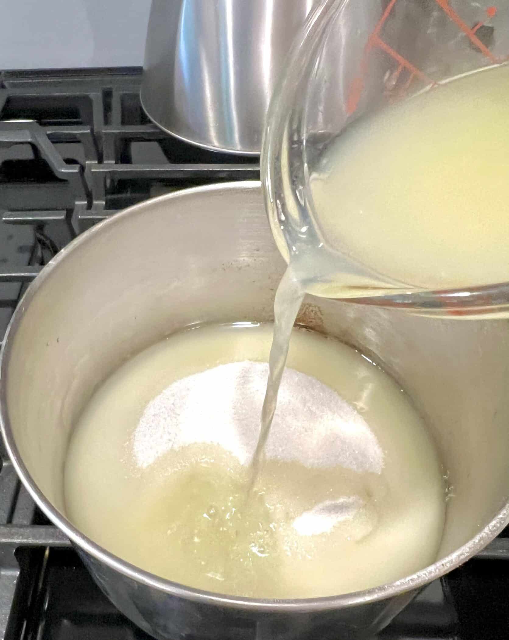 combining sugar and lemon juice in a saucepot