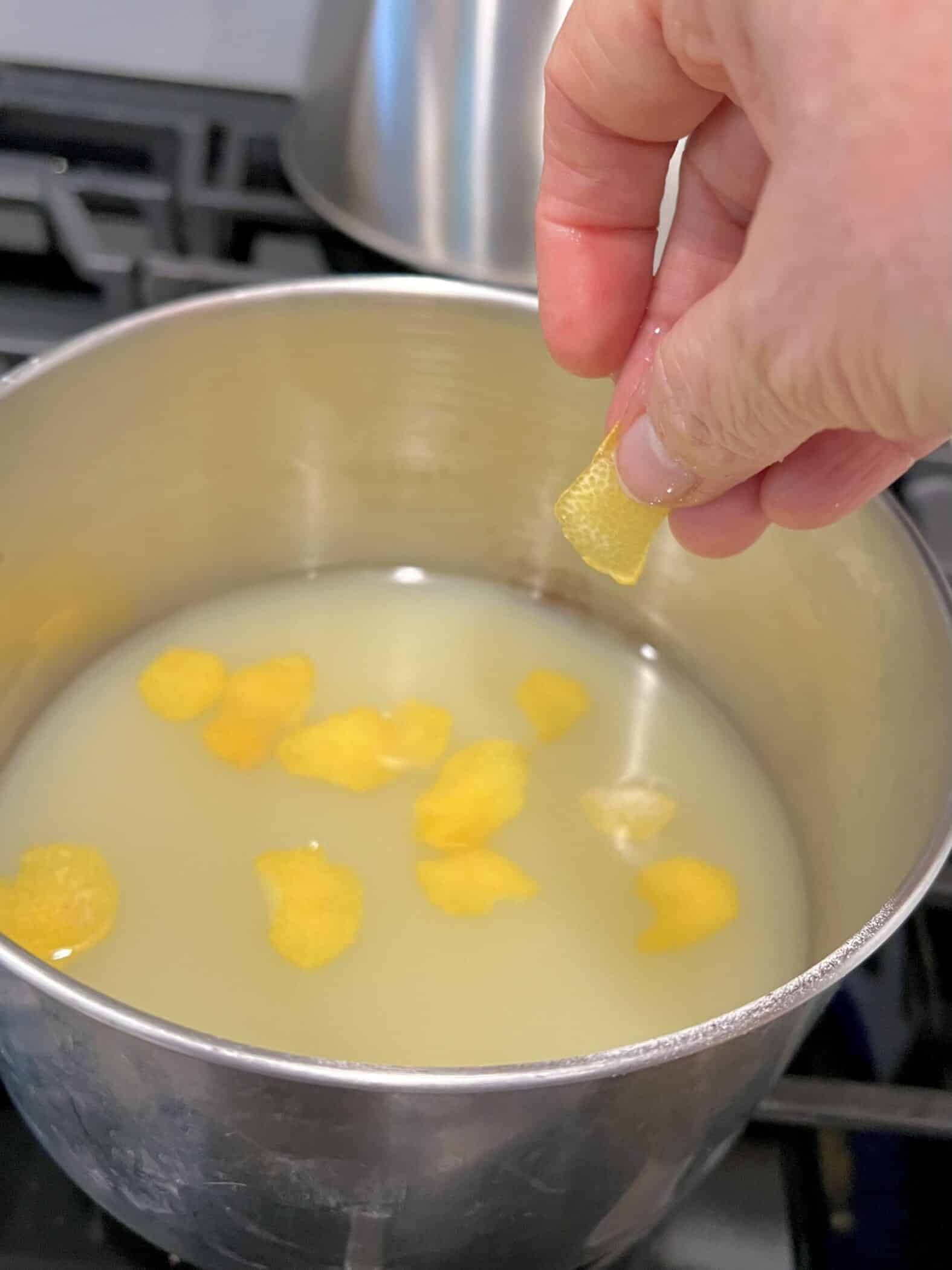 adding lemon rinds to the saucepot