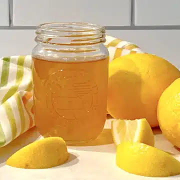 jar of lemon syrup with lemons and striped napkin