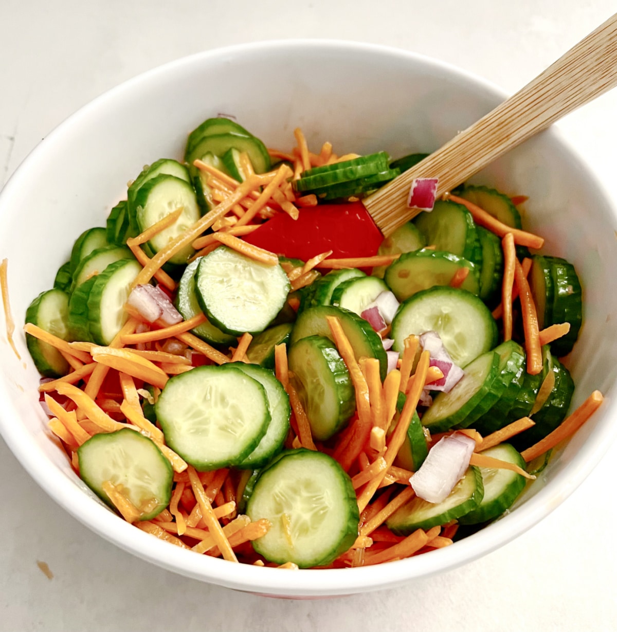 tossing cucumber salad