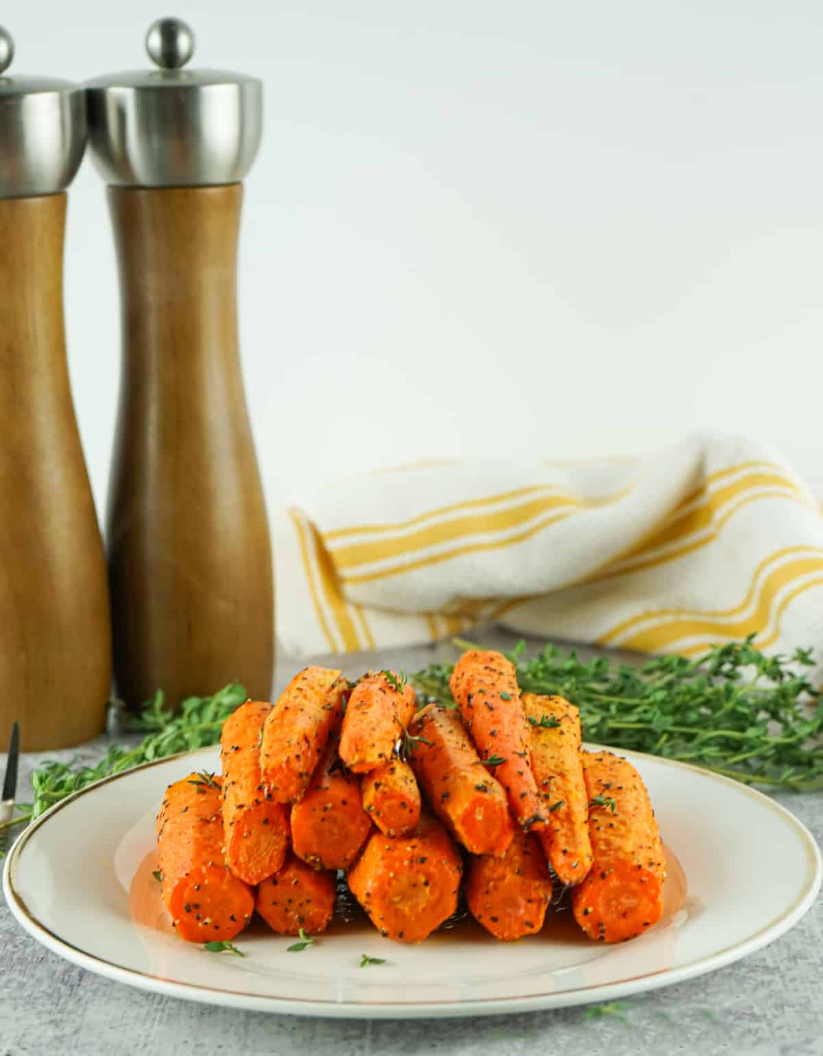 air fried carrots on a platter with salt and pepper shakers