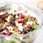 beetroot salad with goat cheese and nuts in a glass bowl