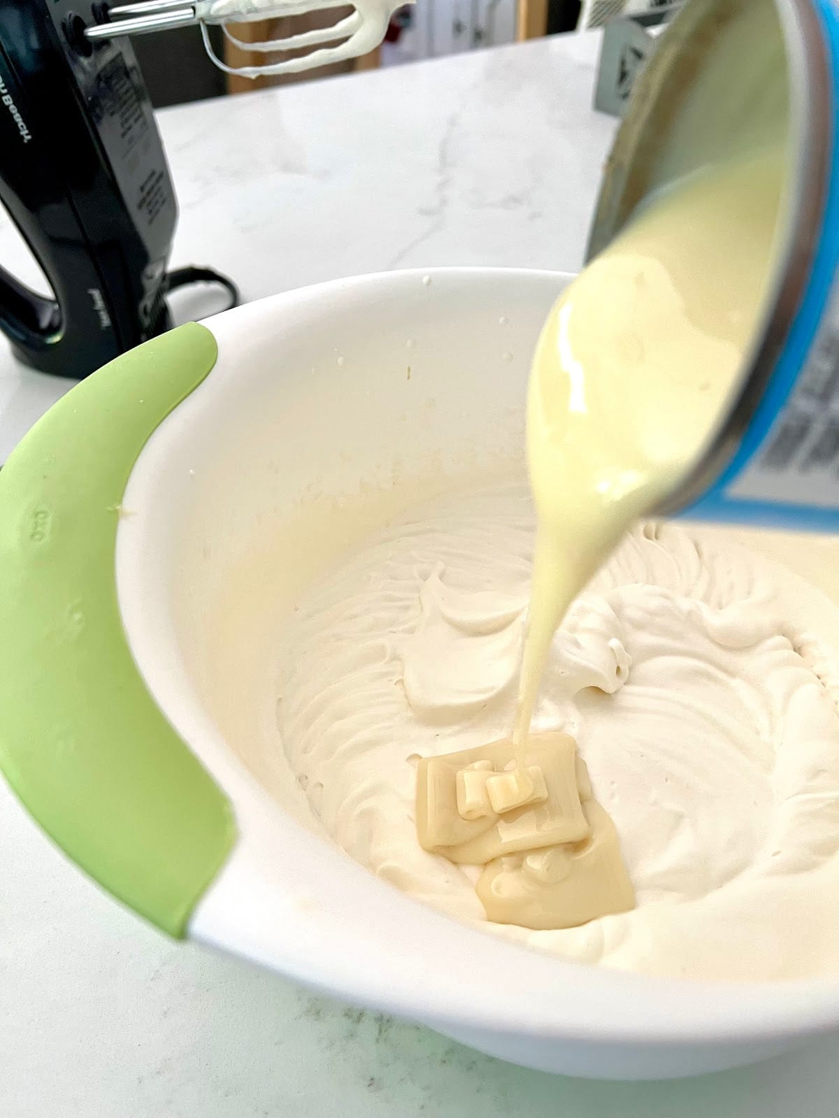 adding sweetened condensed milk to whipped cream
