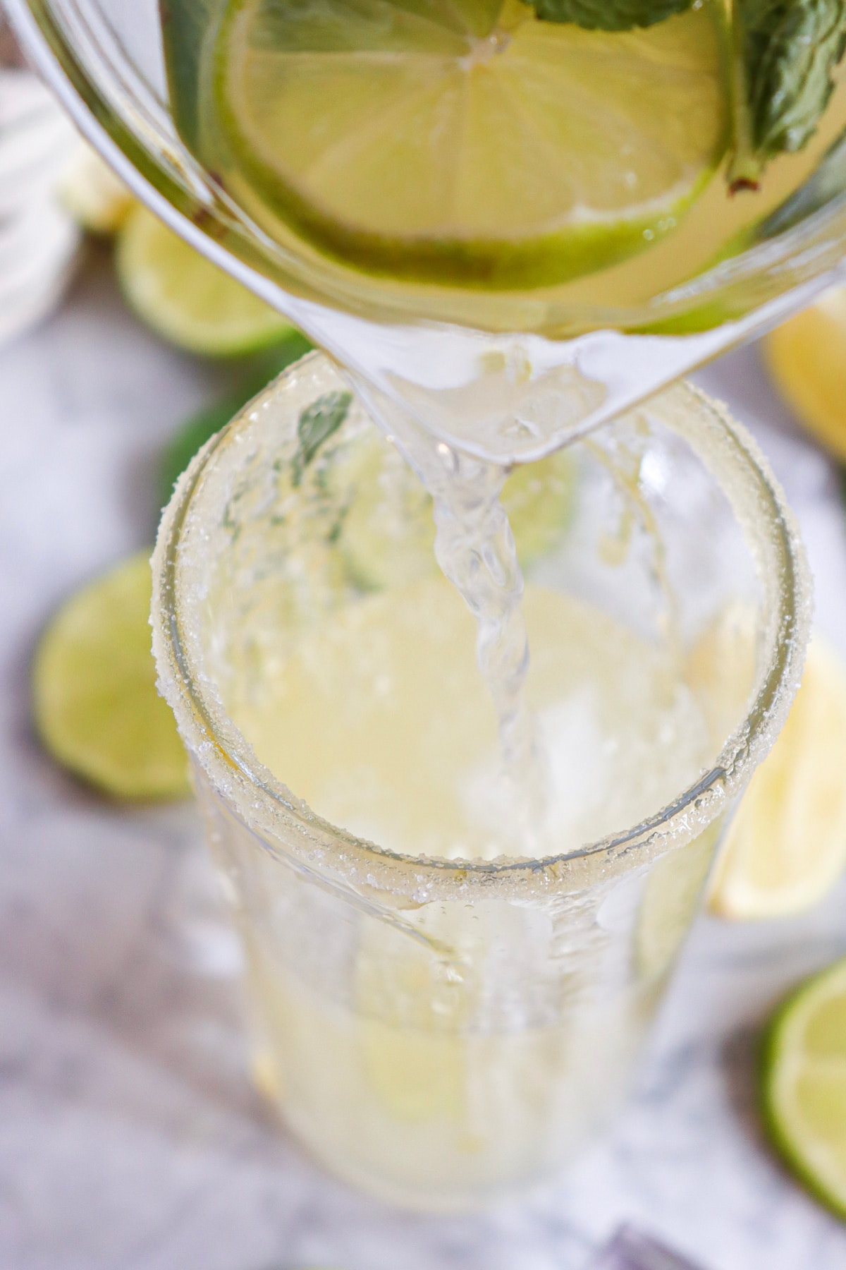 pouring a mojito in a glass