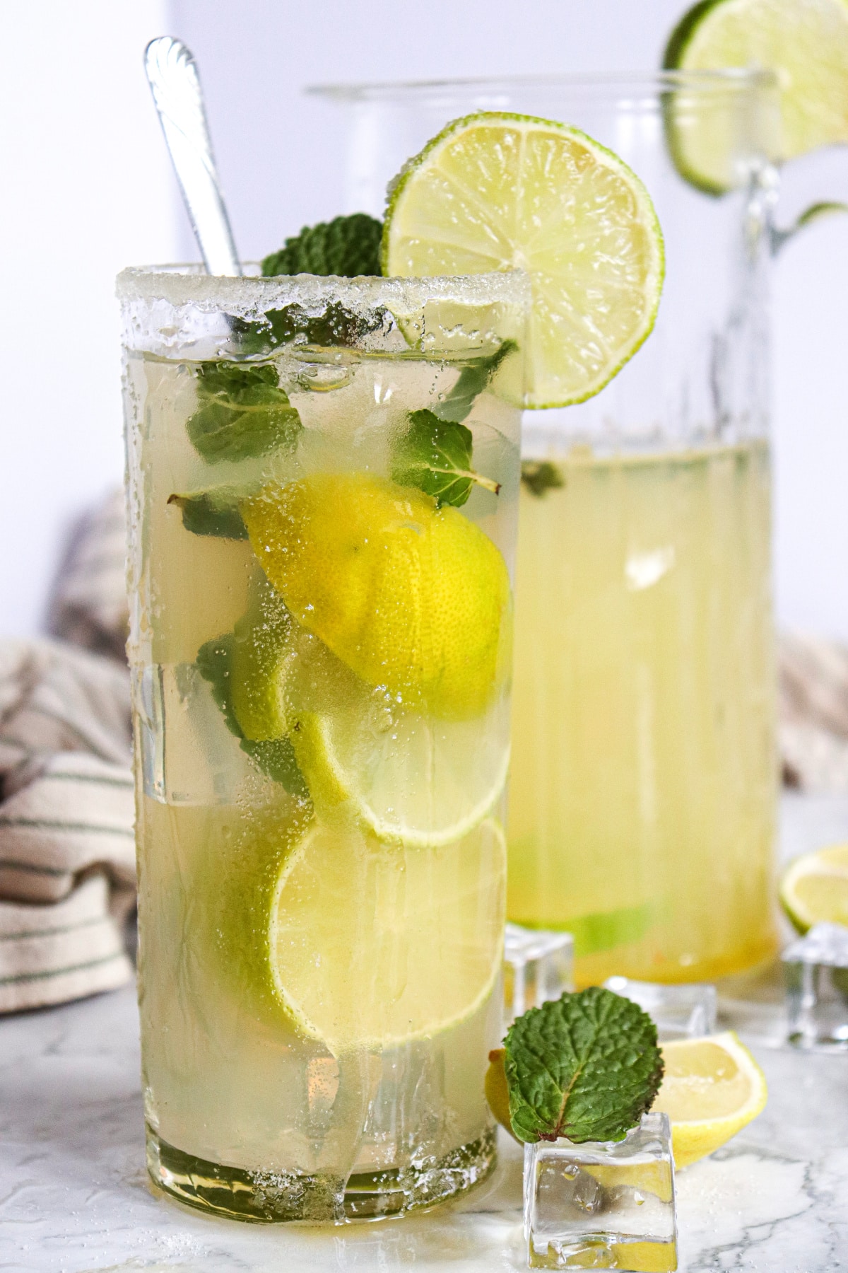 glass of mojito with pitcher 
