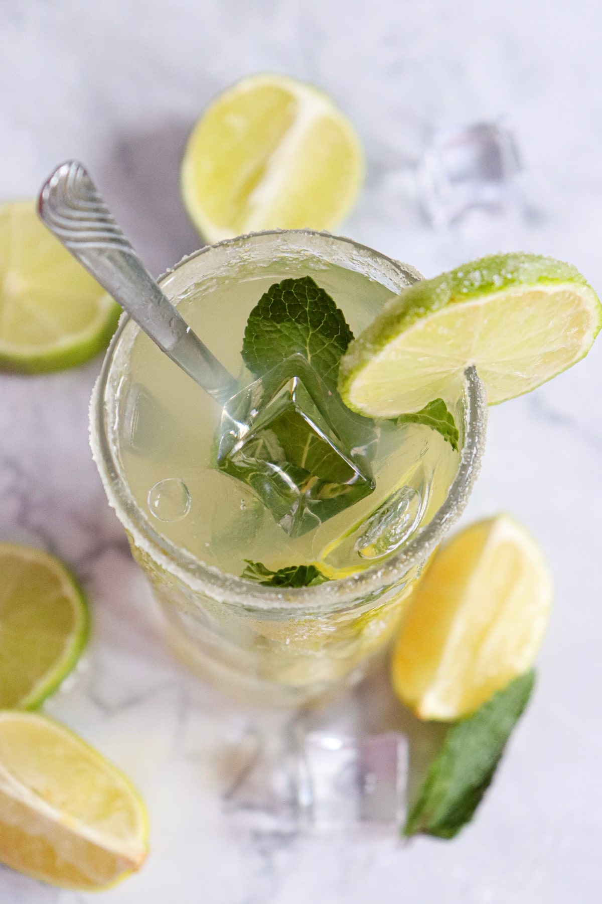 overhead photo of a mojito cocktail with mint and lime