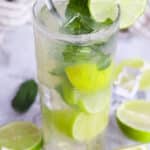mojito cocktail in a clear glass with mint and lime