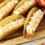 apple pie dessert tacos on a wooden board
