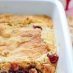 easy cherry dump cake recipe in a baking dish with scoop out