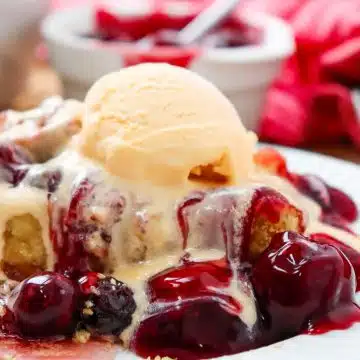 scoop of cherry dump cake with ice cream