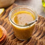 honey mustard marinade in a jar with a small whisk