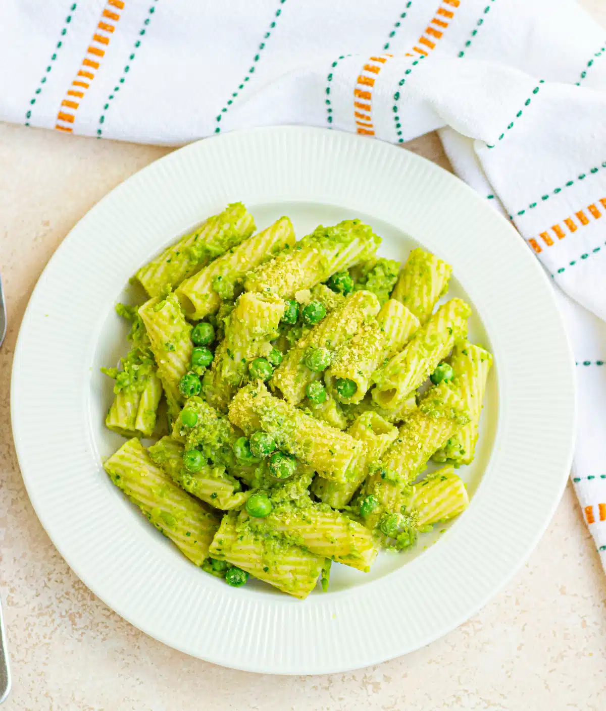 overhead of peas and pasta recipe n a round white bowl