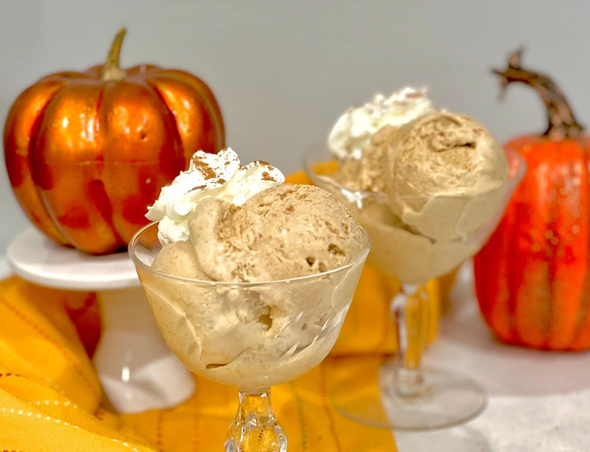 scoops of pumpkin spice ice cream with whipped cream topping