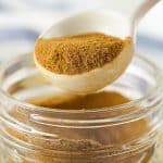 apple pie seasoning in a clear jar with a spoonful