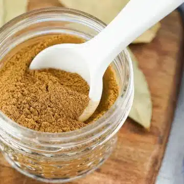 homemade apple pie spice in a jar with a spoon