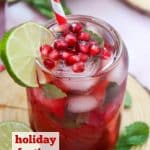 glass of non-alcoholic pomegranate drink with lime slice and arils with text overlay