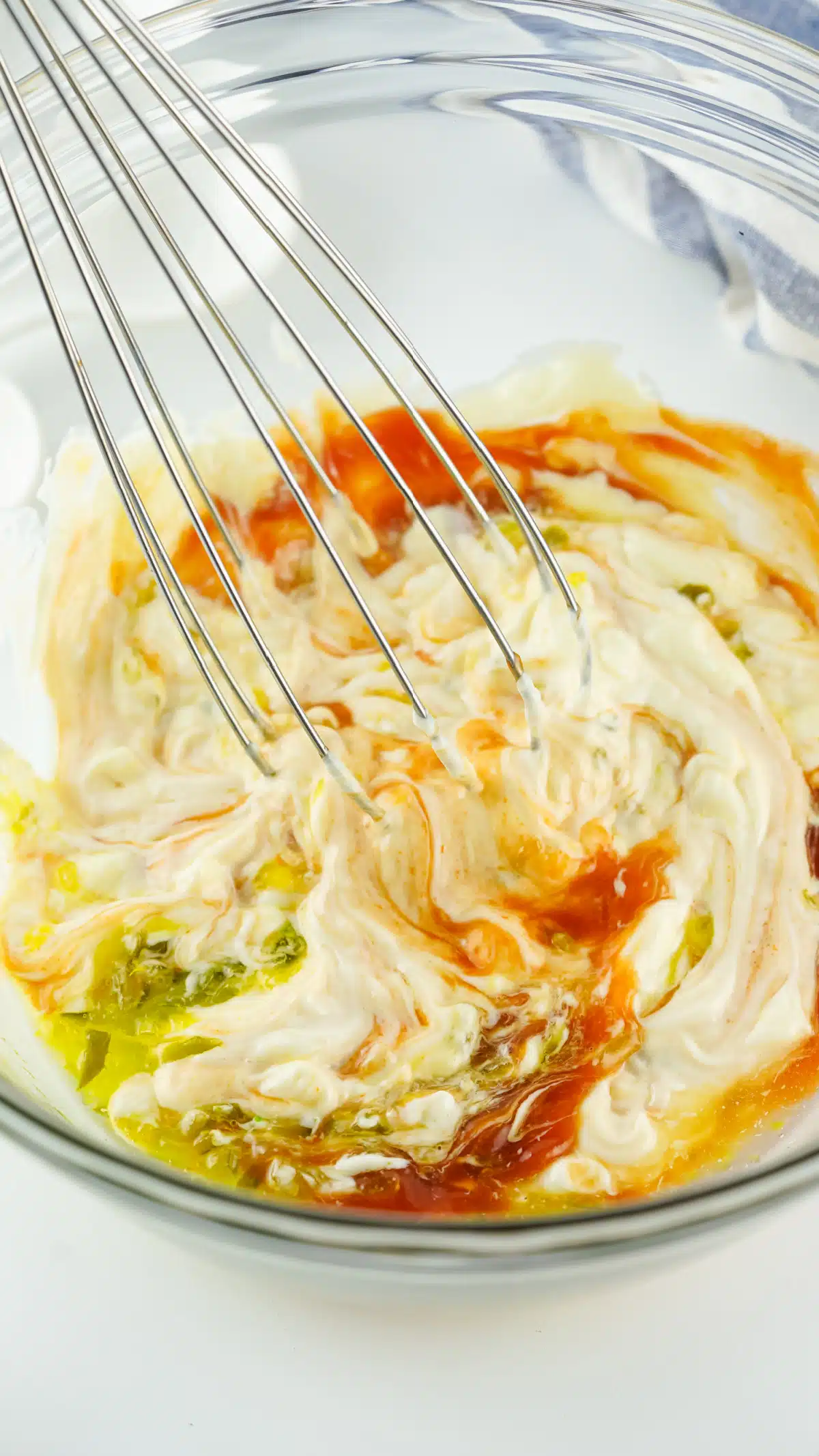whisking sauce ingredients together