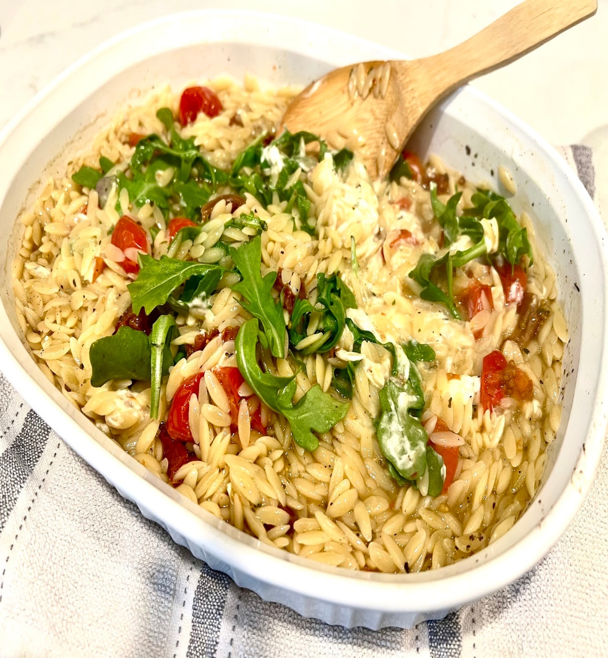 stirring Boursin and arugula into orzo for step 4