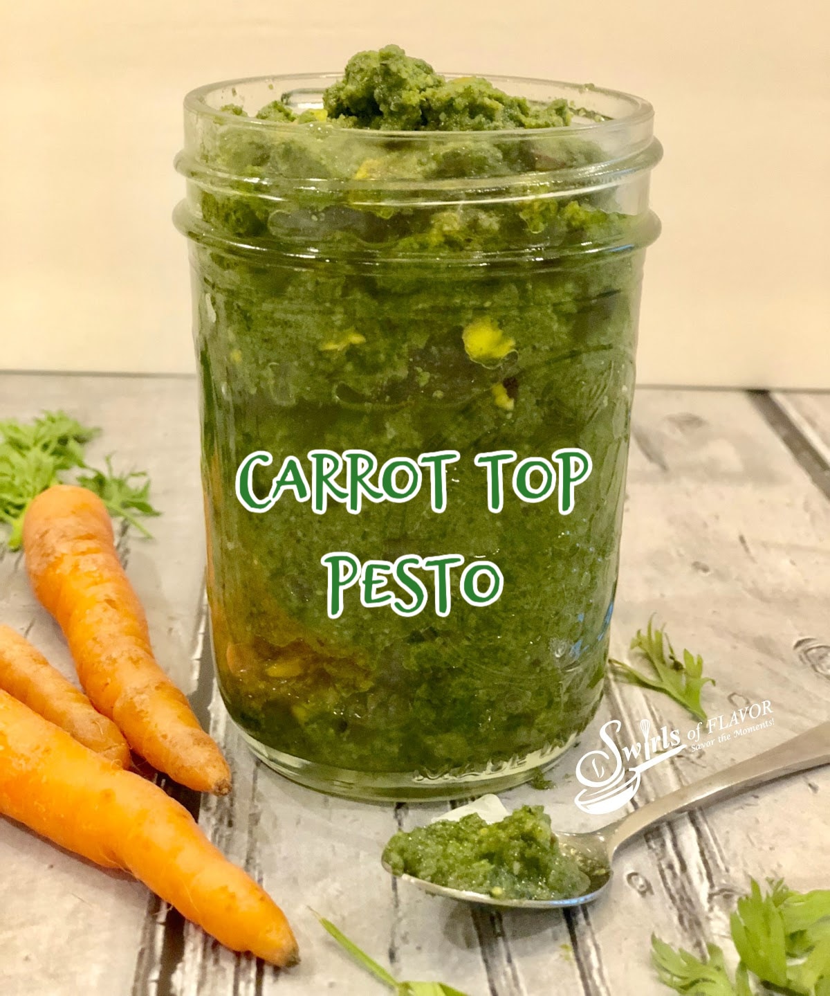 homemade carrot top pesto in a jar with baby carrots