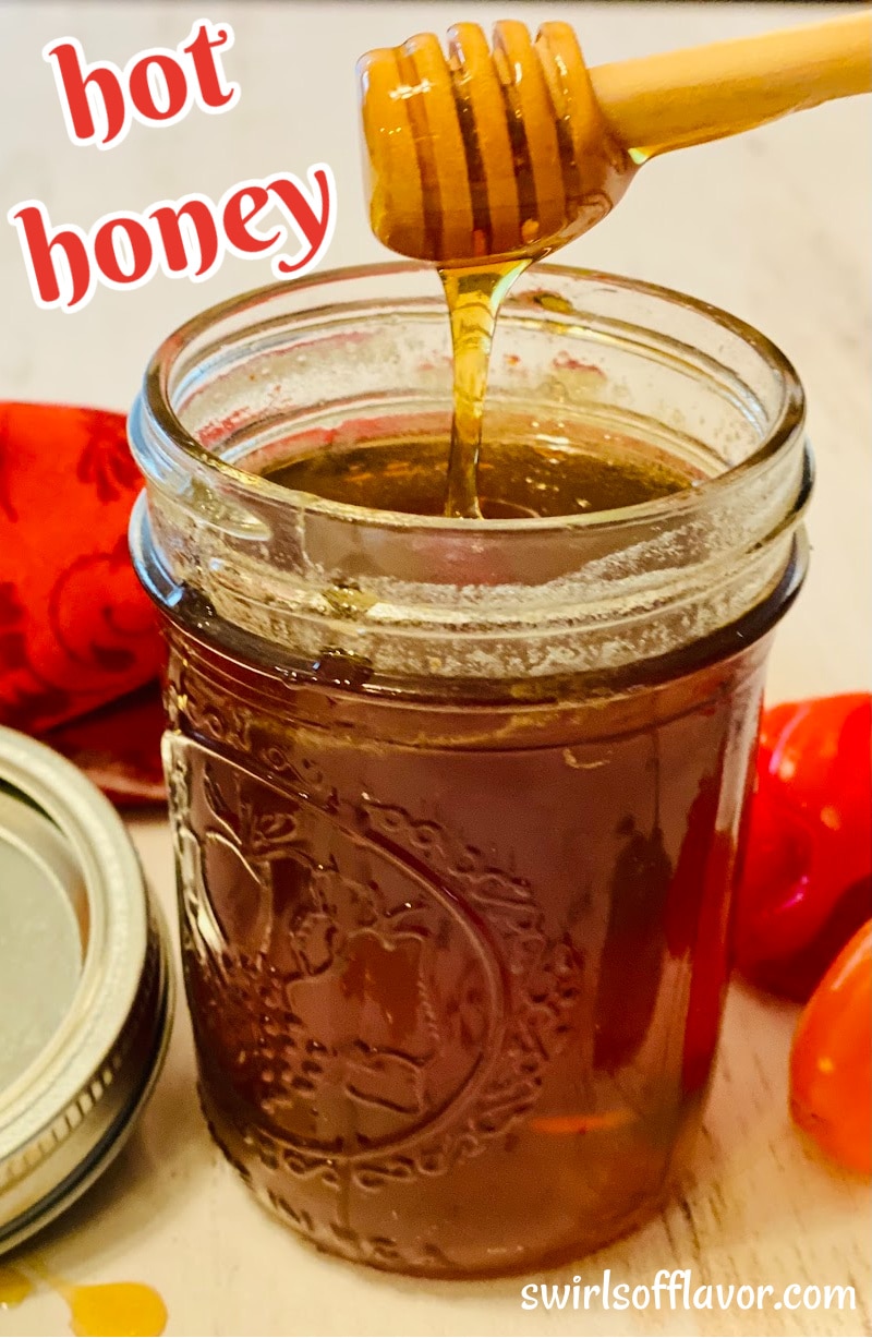 jar of hot honey with a honey dipper