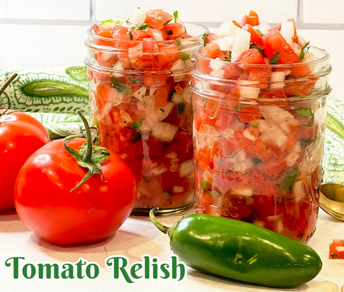 two jars of homemade tomato relish with jalapeno and tomatoes
