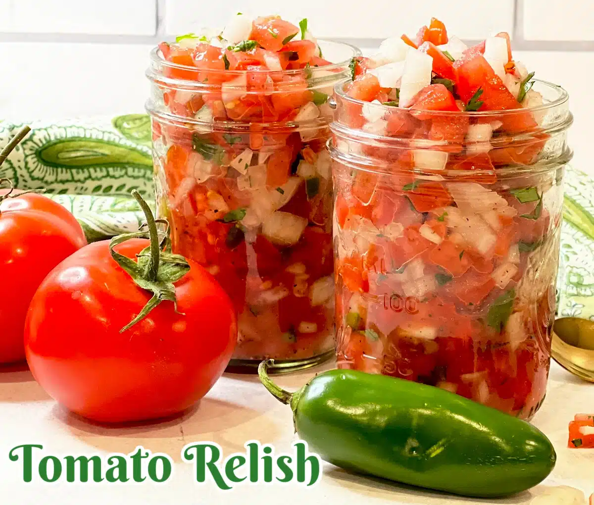 two jars of homemade tomato relish with jalapeno and tomatoes