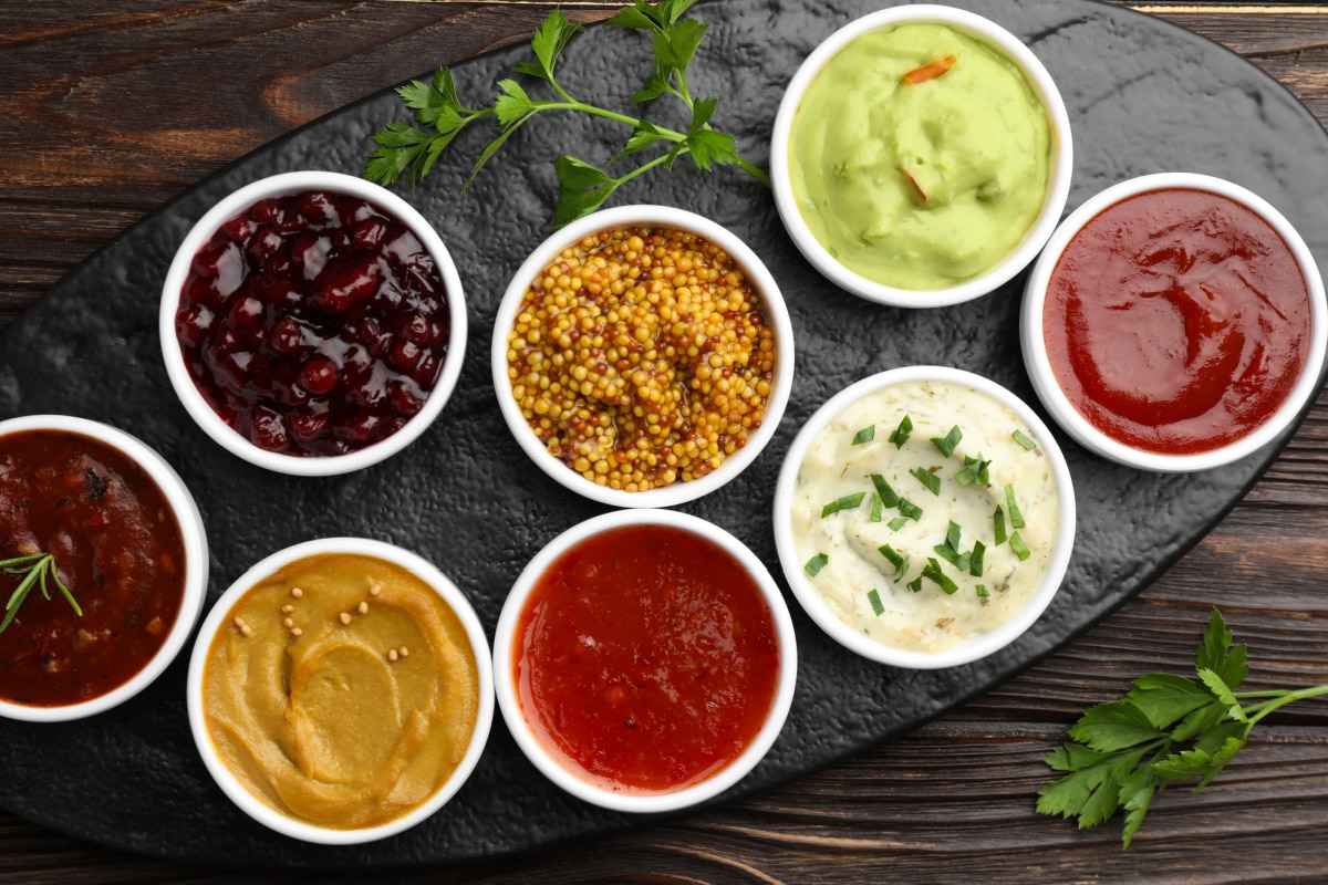 overhead photo of assorted sauces in white bowls