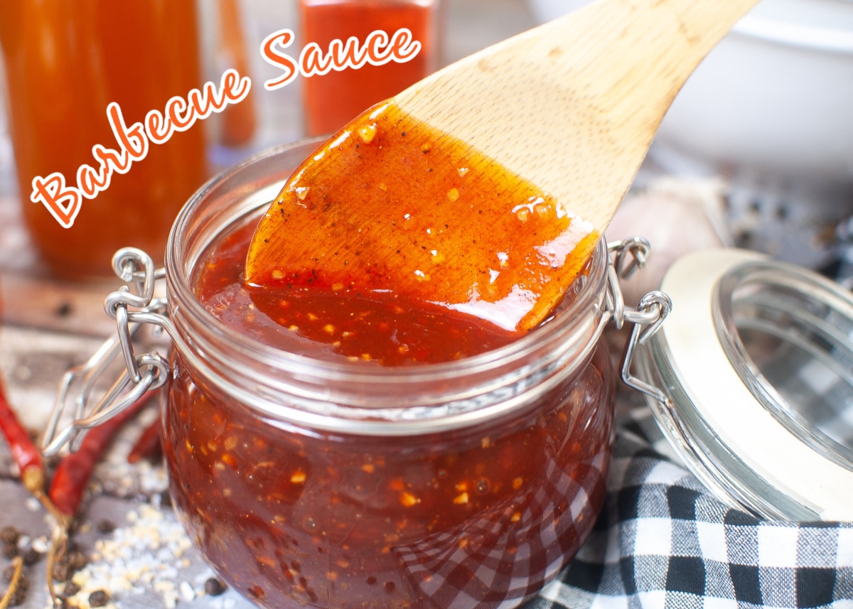 homemade barbecue sauce in glass jar with wooden spoon