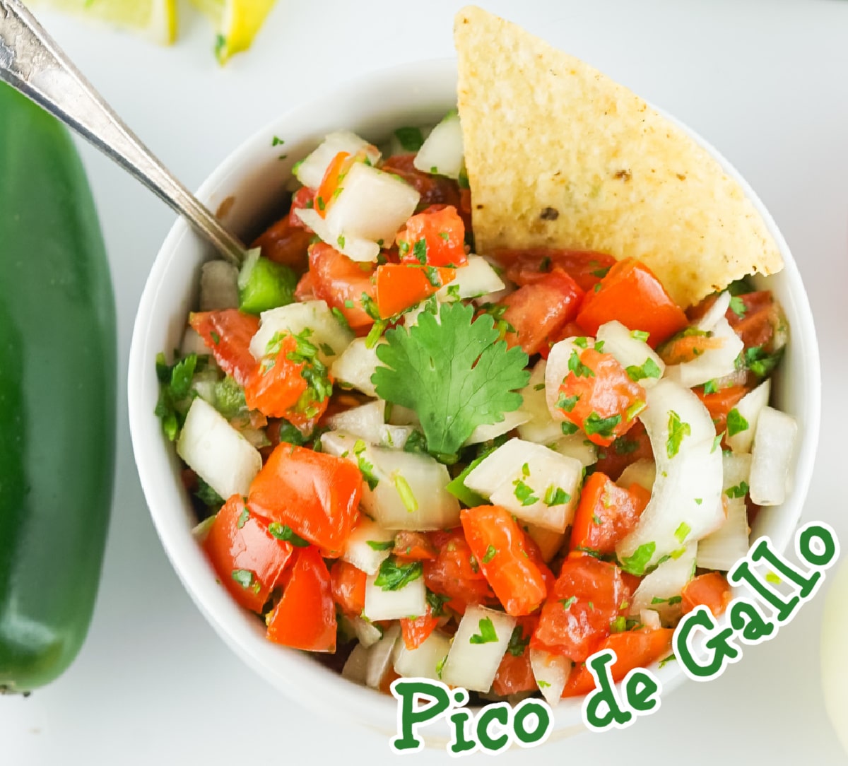 overhead photo of a bowl of pico de gallo with a tortilla chip